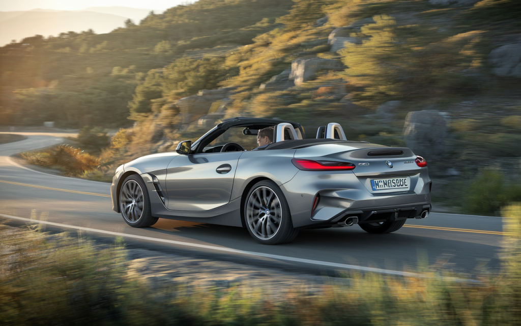 BMW Z4 cabriolet argenté sur route de montagne au coucher du soleil